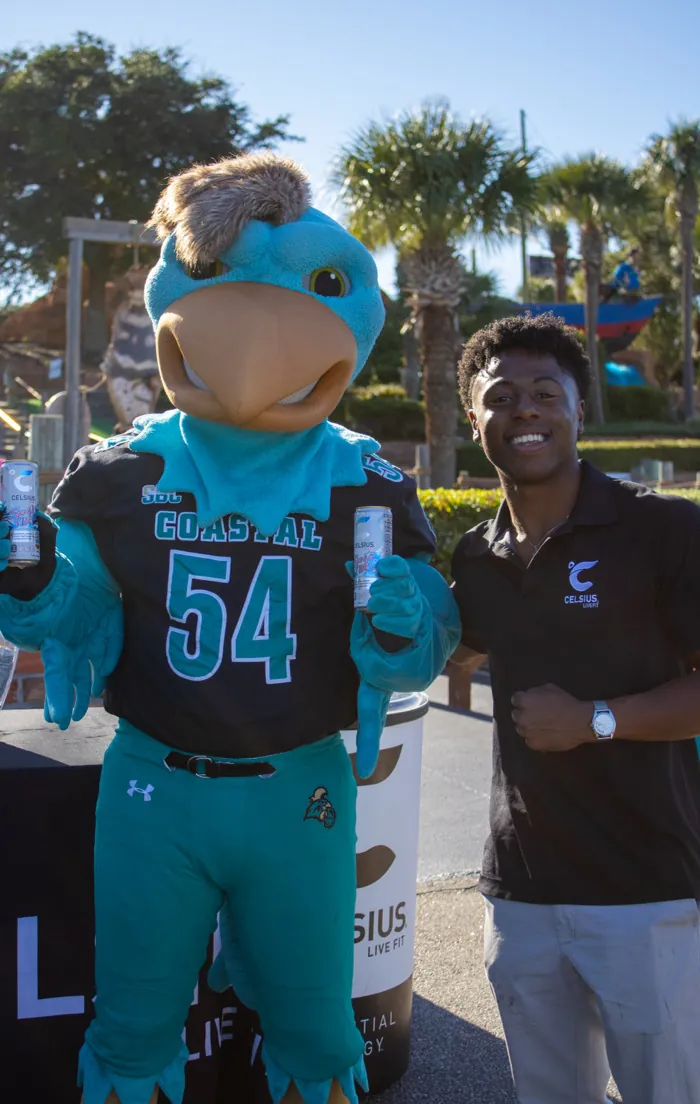 Siah with the Coastal Carolina mascot at a Celsius sampling activation